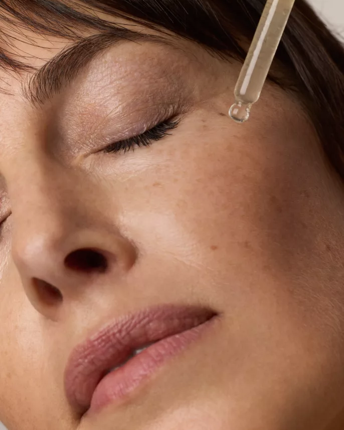 Application de sérum anti-âge autour des yeux – gros plan beauté sur modèle mature, photographie cosmétique réalisée à Lyon par photographe spécialisée.